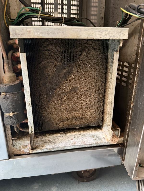 Refrigeration condenser blocked with dust and grease before cleaning