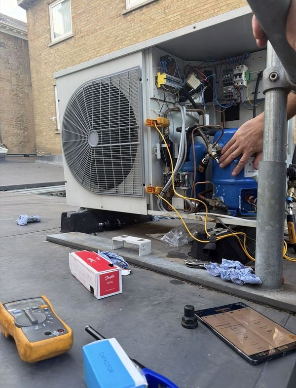 Engineer repairing an outdoor refrigeration condensing unit