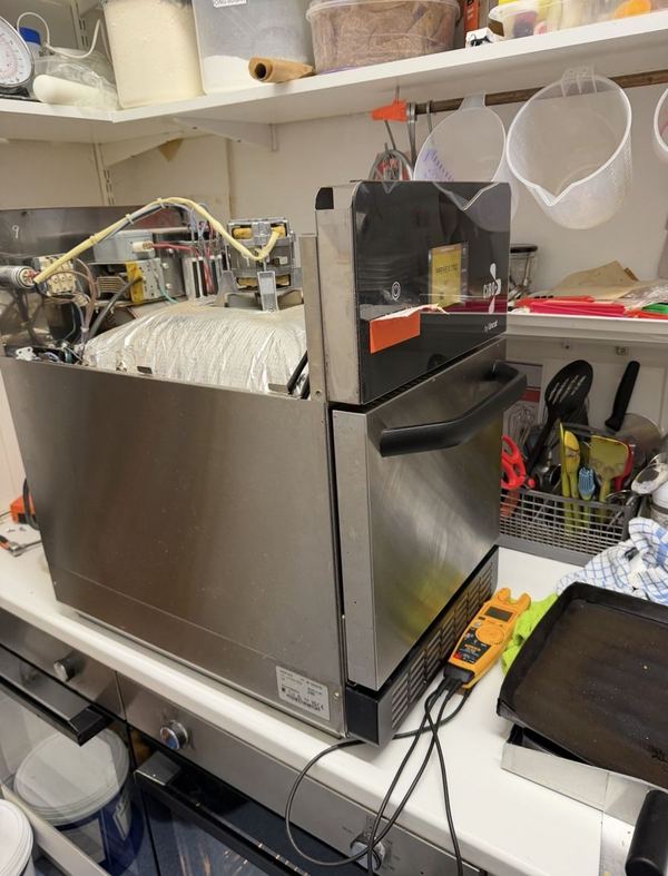 Electric fryer being tested with a meter after a repair