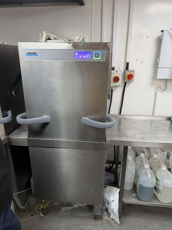 Pass-through hood dishwasher back in service in a commercial kitchen