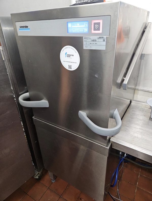 Winterhalter pass-through hood dishwasher in a commercial kitchen